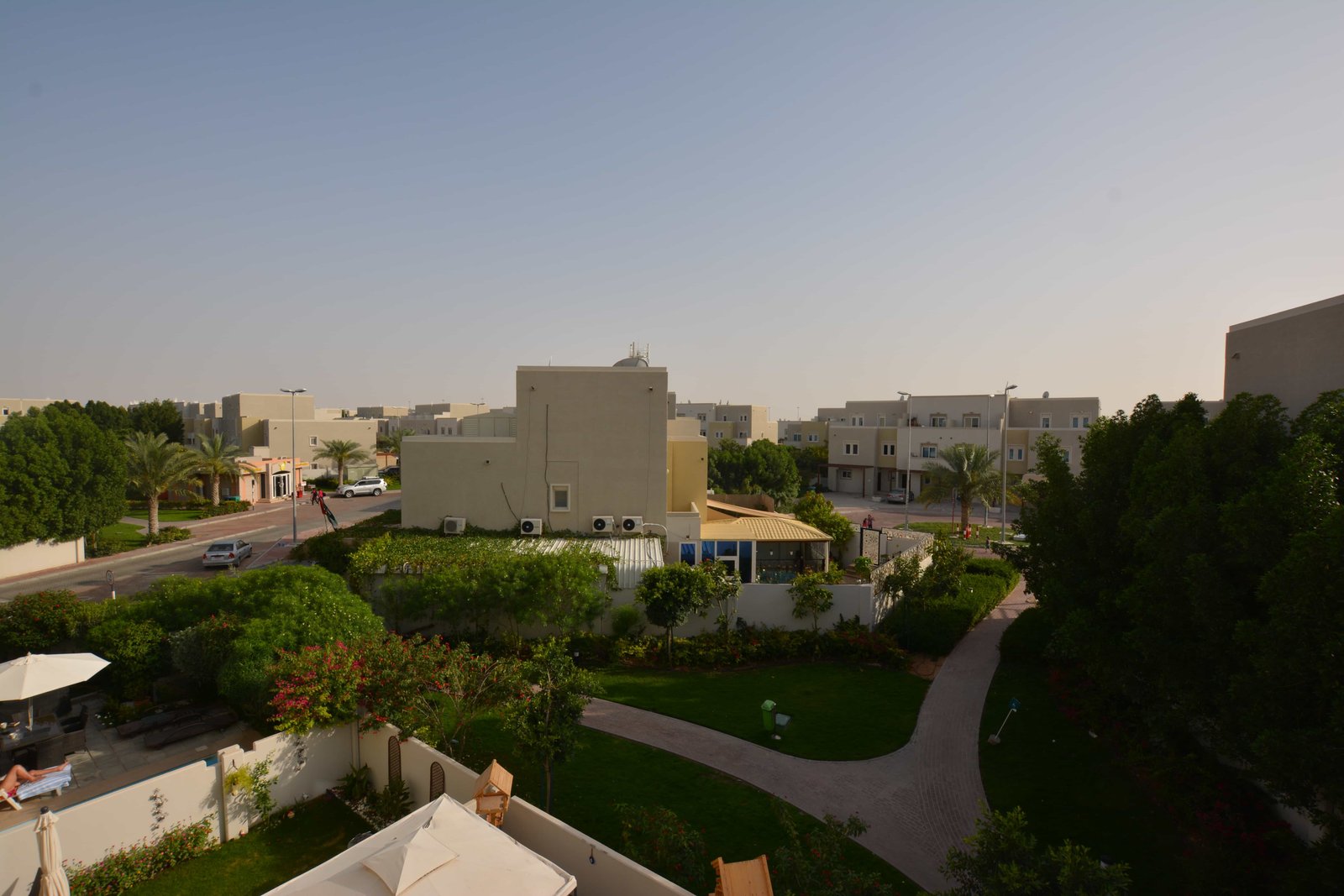 Street-level perspective of Desert Villas Abu Dhabi highlighting contemporary façades and family-friendly community layout.