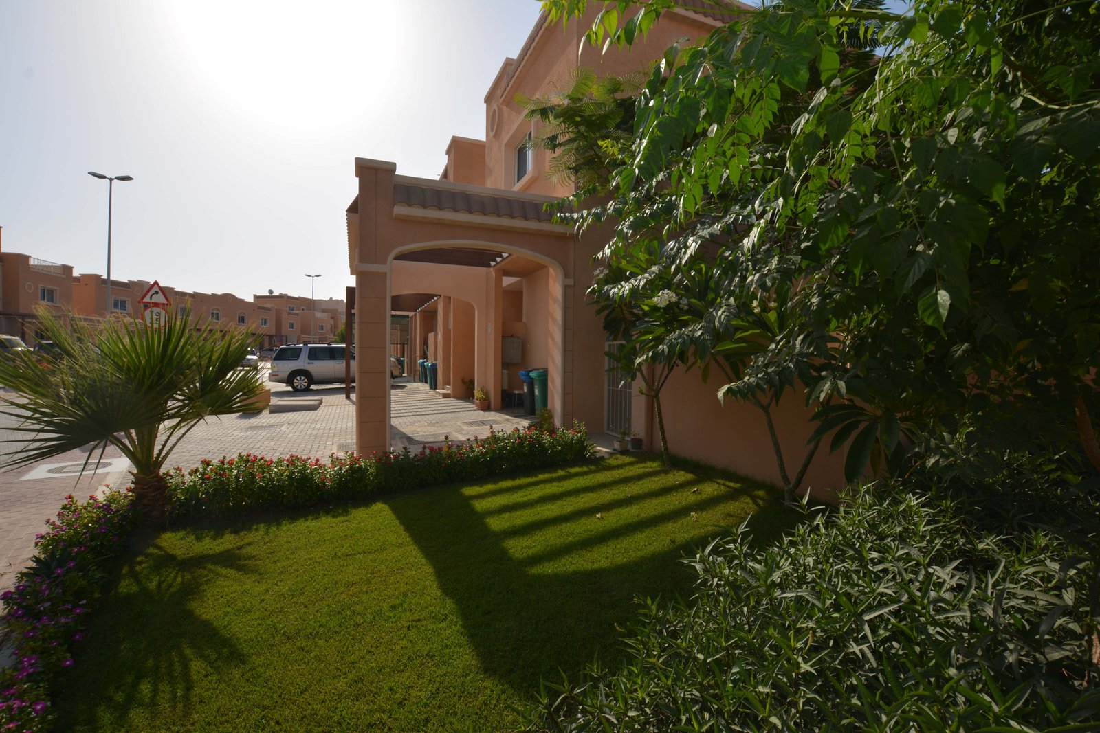 Front view of Al Reef Mediterranean Villas Abu Dhabi showcasing Mediterranean-style architecture, terracotta roofs, and landscaped gardens.